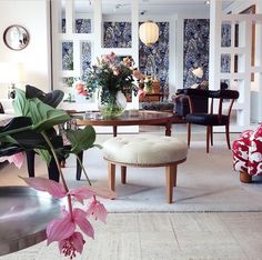 a living room filled with furniture and flowers