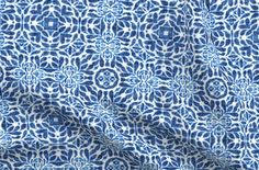 a blue and white fabric with an intricate design