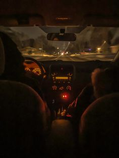 the interior of a car at night with lights on