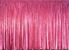 a pink curtain is hanging on the wall