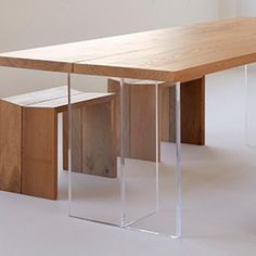 a wooden table sitting on top of a white floor