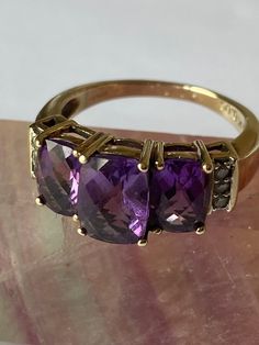 Vintage - Amethyst and Diamond 9ct Gold Three Stone Ring - in a stepped claw setting, with three claw set diamonds either side - c1980's. The three Stone Amethyst is Facet Cut and graduated. Stunning vintage statement ring/ engagment ring - graduation present. Ring Size - N/O UK - US 7 1/4 Luxury Vintage Amethyst Ring With Polished Finish, Luxury Antique Amethyst Ring, Luxury Vintage Gold Amethyst Ring, Antique Amethyst Ring Gold, Vintage Amethyst Ring, Amethyst Ring Vintage, Graduation Present, Three Stone Ring, Claw Setting