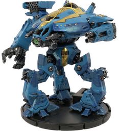 a blue and yellow robot is standing on a black base