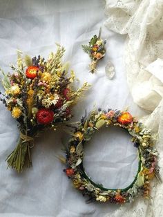 two wreaths made out of flowers on a white sheet