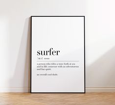 a black and white poster with the words surfer on it in front of a wall