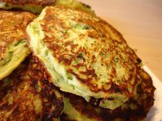 there are several pancakes stacked on top of each other with cheese and broccoli