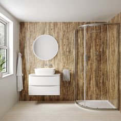 a bathroom with wooden walls and flooring is shown in this image, there is a sink, toilet, shower stall and mirror on the wall