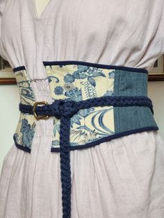 a woman wearing a blue and white belt