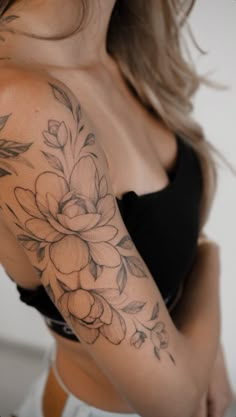 a woman with a flower tattoo on her arm