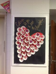 a heart made out of cups on a wall