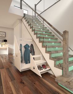 an open closet under the stairs with shoes and coats on it, next to a stair case