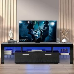 a flat screen tv sitting on top of a black entertainment center