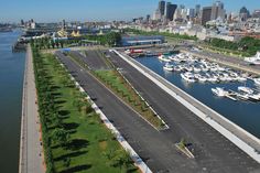 an aerial view of a marina with boats in the water and cityscape in the background