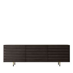 the sideboard is made out of dark wood and has brass legs on each side