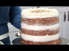 a cake with white frosting and sprinkles on it