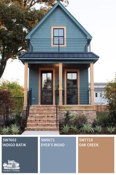 a blue house with brown trim and windows