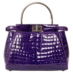 Borsa firmata Fendi, modello Peekaboo, misura mini, reaizzat in pelle viola con hardware argentati. Dotata di una doppia chiusura a girello fronte retro, internamente rivestita in pelle liscia viola, capiente per l’essenziale. Munita di un manico centrale rigido per portata a mano, e di una tracolla sottile in pelle cocco, rimovibile e regolabile. Caratterizzata da bottoni ad incastro laterali e da piccola tasca interna con chiusura a zip. Si presenta in ottime condizioni. ______________________ Fendi Peekaboo Mini, Chanel Coco Handle, Fendi Casa, Louis Vuitton Limited Edition, Fendi Peekaboo, Vintage Fendi, Suede Tops, Togo Leather, Purple Leather