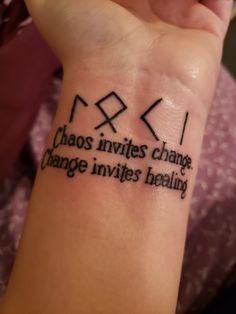 a person with a tattoo on their wrist that says chaos inverts change, change invites reality