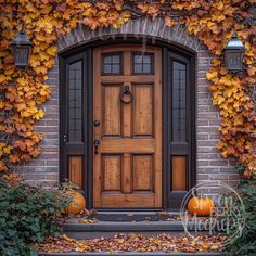 a wooden door surrounded by leaves and pumpkins