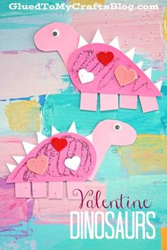 two pink paper dinosaurs with hearts on their heads and the words valentine dinosaurs written in white