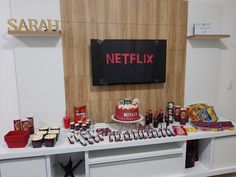 a table topped with a cake and lots of snacks