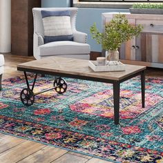 a living room with a couch, chair and coffee table on top of a rug