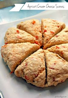 a white plate topped with sliced up scones on top of a blue table cloth