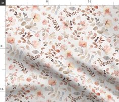 a white fabric with pink flowers and leaves on the side, next to a ruler