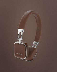 the headphones are brown and have silver trimmings on them, which is attached to