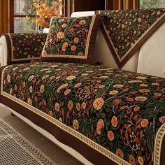 a bed covered in a green and orange floral comforter with matching pillow shampoos