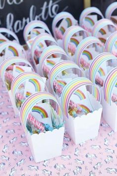 there are many rainbow candy boxes on the table