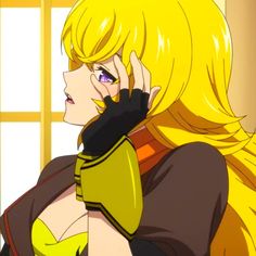 a woman with blonde hair talking on a cell phone in front of a yellow window