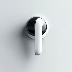 a white door handle on a grey wall