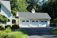 a white house with two garages on each side