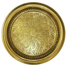 a gold plate with intricate designs on it