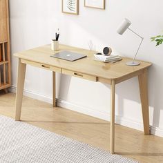 a wooden desk with a laptop on it