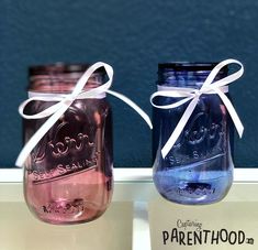 two blue and pink mason jars tied together