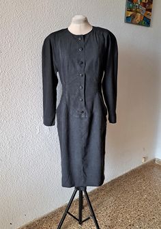 This fabulous, stylish dress BY Karl Lagerfeld crafted from faded black solid silk, two front pockets, front closure with  buttons with KL signature, long raglan sleeves with pads, rear belt, fully lined. Color: Black Marked: 100% silk, lined - 100% viscose. Size: D - 38, F - 40, GB - 12, I -44, USA - 8. Made in Germany. Measurements taken flat: armpit to armpit: 49 cm / 19.2'' waist: 43 cm / 16.9'' length: 110 cm / 43.2'' Condition: excellent vintage Karl Lagerfeld Dress, Black Silk Dress, Dress Designer, Mid Length Dresses, Black Silk, Dress Clothes For Women, Stylish Dresses, Karl Lagerfeld, Raglan Sleeve