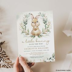 a person holding up a little bunny birthday card