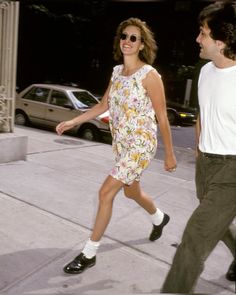 a man and woman walking down the street