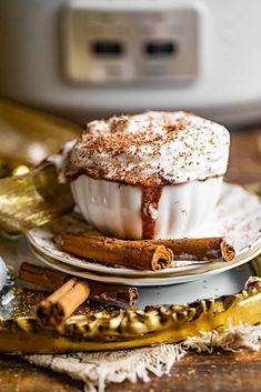 a hot chocolate dessert on a plate with cinnamon sticks