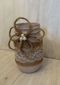 a mason jar decorated with twine and lace