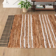 a living room with wooden floors and a rug on the floor in front of a coffee table