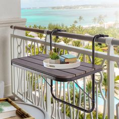 a balcony with an ironing board and potted plant on the railing next to it