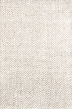 a white rug with an arrow pattern on the top and bottom, in front of a gray background