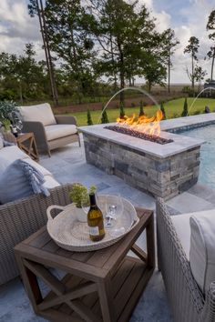 a fire pit sitting next to a swimming pool