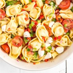 a white bowl filled with pasta and vegetables