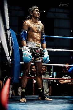 a man standing in the middle of a boxing ring