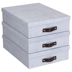 three drawers are stacked on top of each other, one is grey and the other has brown handles