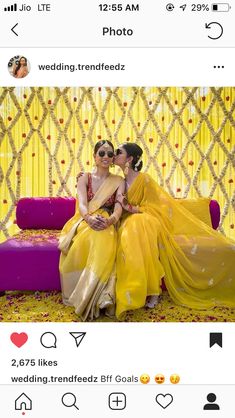 two women in yellow dresses sitting on a couch